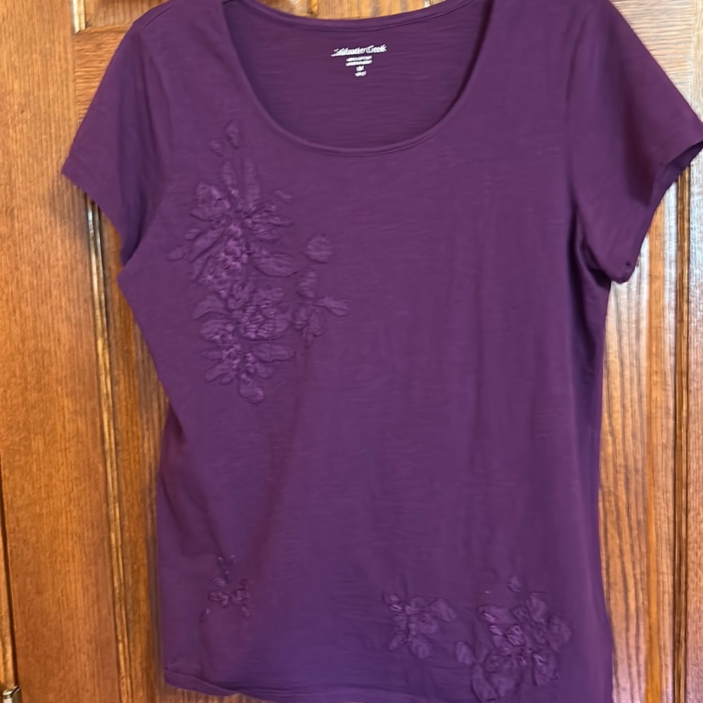 Coldwater Creek purple top. Floral designs NWOT Capped sleeves. Size Medium.